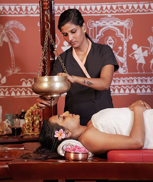 Shirodhara therapy at Akanta Ayurveda & Yoga Cherai, a serene ayurvedic resort in Kerala, promoting deep relaxation and mental calm