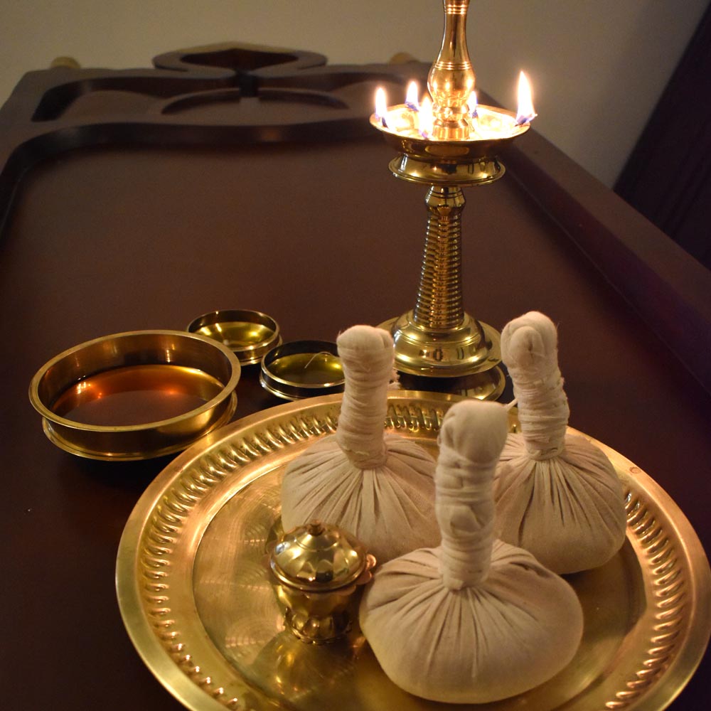 Traditional Podi Kizhi Ayurvedic massage with heated herbal poultices