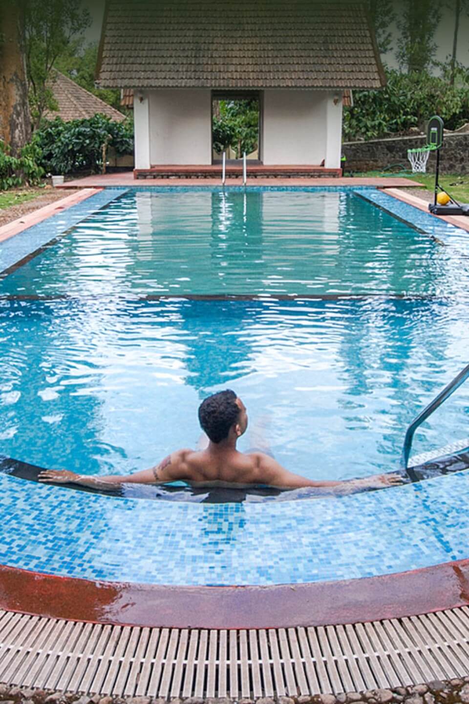 Serene swimming pool at Misty Woods Resort Coorg with natural surroundings
