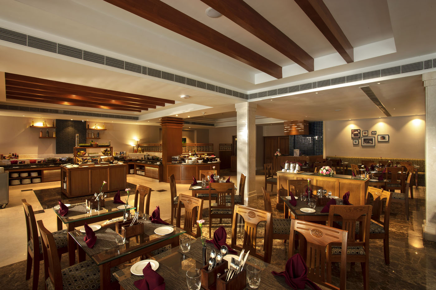 Curry Sense multi-cuisine restaurant at Monsoon Empress in Kochi featuring a spacious ground-floor dining area serving global delicacies with an elegant ambiance and gourmet buffet spread.