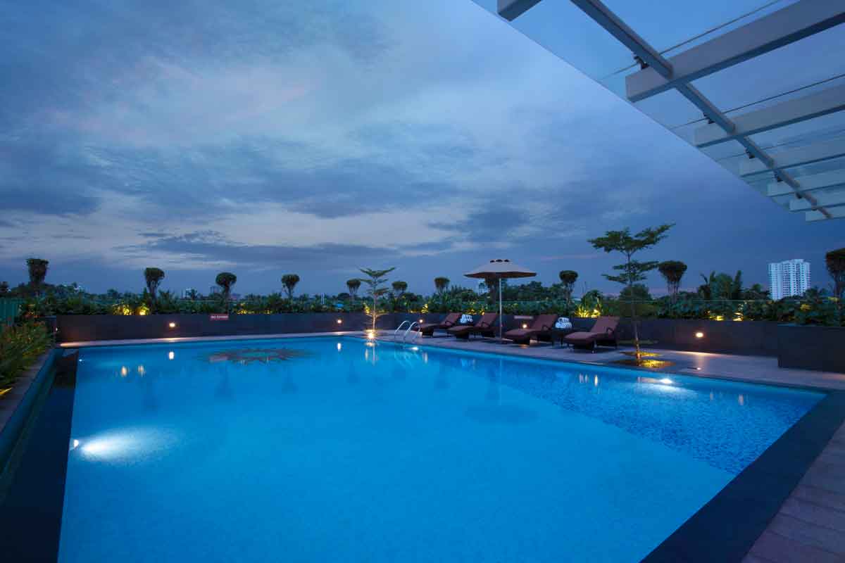Rooftop swimming pool at Monsoon Empress, one of the best 5 star hotels in Kochi, offering city views and a relaxing atmosphere.